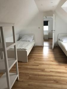 a bedroom with two beds and a ladder in it at Nordseeküste am Deich mit schönem Garten in Neßmersiel
