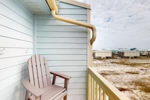 a chair sitting on the porch of a house at Summer House West Condos in Gulf Shores