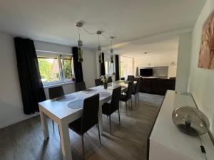 a living room with a white table and chairs at Ferienhaus Wachwitzgrund in Dresden