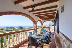 フリヒリアナにあるVilla Suspiroのバルコニーにテーブルと椅子が置かれたダイニングルーム