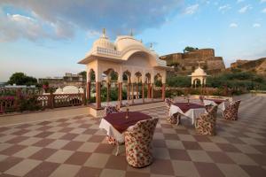 a pavilion with tables and chairs on a checkered floor at Shahpura Haveli in Shāhpura