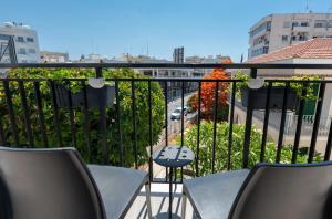 a balcony with chairs and a view of a street at Rise Urban Art Hotel in Larnaca