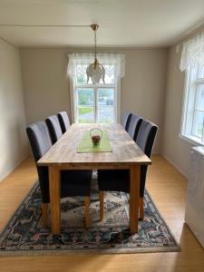 a dining room with a wooden table and chairs at Nordlandshus Lofoten in Berg