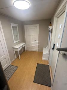 a room with a white table and a door at Nordlandshus Lofoten in Berg +8 photos