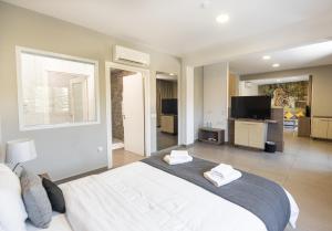 a bedroom with a large bed with two towels at Rise Urban Art Hotel in Larnaca