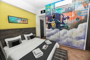 a bedroom with a football mural on the wall at Rise Urban Art Hotel in Larnaca