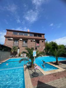 a large swimming pool in front of a building at Best House in Kobuleti