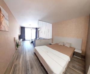 a bedroom with a large bed in a room at Art Sense Мезонет in Shkorpilovtsi