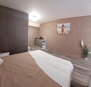 a bedroom with a large bed in a room at Art Sense Мезонет in Shkorpilovtsi +33 photos