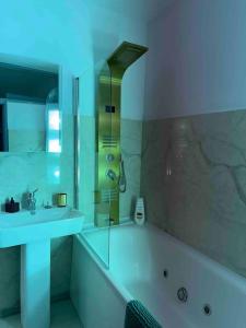 a white bathroom with a tub and a sink at Downtown luxury segment in Braşov