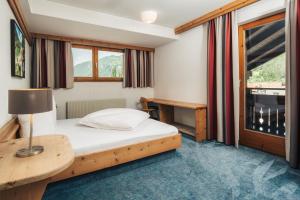 Postel nebo postele na pokoji v ubytování Ferienresidenz Raich - Appartements mit Sky Wellness und Garten