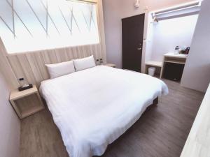 Rúm í herbergi á AOIKE Hot Spring Hotel
