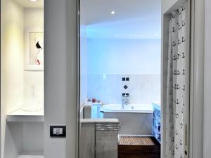 a bathroom with a sink and a bath tub at La Teresiana apartment in Trieste +16 photos