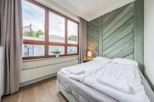 Katil atau katil-katil dalam bilik di Apartamenty Martini