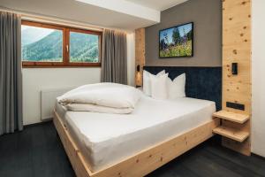 Postel nebo postele na pokoji v ubytování Ferienresidenz Raich - Appartements mit Sky Wellness und Garten