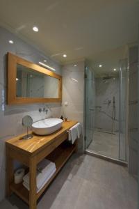 a bathroom with a sink and a shower at Parga Inn Suites in Parga +37 photos