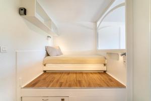a small bedroom with a bed in a small room at La Cigale Varoise - Hyères La Plage in Hyères
