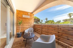a room with two chairs and a table on a balcony at La Cigale Varoise - Hyères La Plage in Hyères