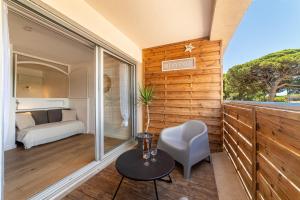 a room with a table and a chair and a bed at La Cigale Varoise - Hyères La Plage in Hyères