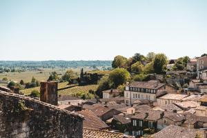 a view of a village with houses andyards at logis-des-cordeliers in Saint-Émilion +33 photos