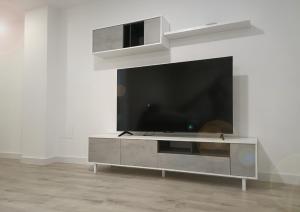 a large entertainment center with a large television on a wall at Casa Pastor in Murcia