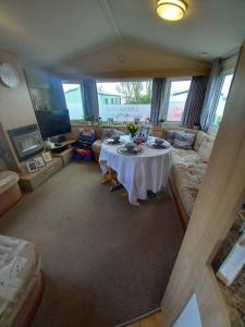 a living room with a table and a couch at Tunstall J&D Caravan on the East Coast in Tunstall