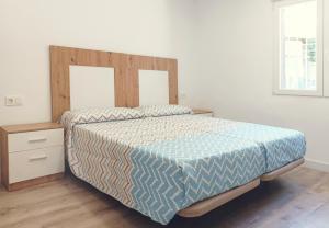 a bedroom with a bed with a wooden headboard at Casa Pastor in Murcia