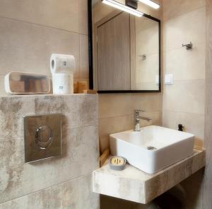 a bathroom with a white sink and a mirror at House Rytha in Limenaria +60 photos