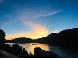 a view of a river at sunset at Mekong Backpackers in Pakbeng