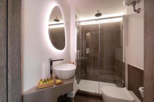 a bathroom with a sink and a toilet and a shower at The Point Suites Rome - Guest House in Rome