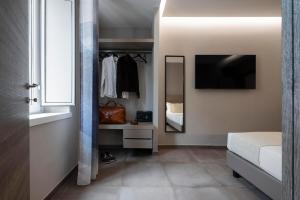 a bedroom with a bed and a dresser and a mirror at The Point Suites Rome - Guest House in Rome