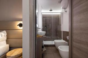 a bathroom with a toilet and a sink and a shower at The Point Suites Rome - Guest House in Rome