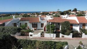 a large white house with red roof at Charming house with sea view in Valledoria in Valledoria