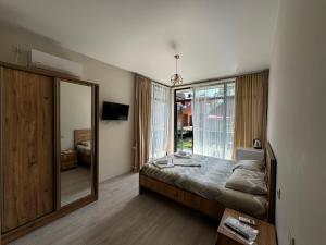 a bedroom with a bed and a large mirror at Best House in Kobuleti