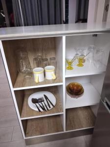 a white shelf with a plate and utensils on it at Idyllic Villa in Pereybere with Private Pool in Pereybere