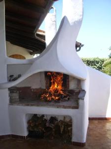 a fireplace is shown with a fire in it at Charming house with sea view in Valledoria in Valledoria