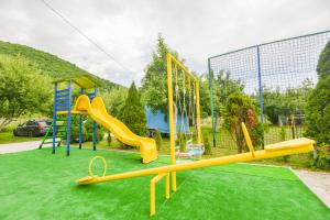 einen Spielplatz mit gelber Rutsche in der Unterkunft Villa Miris Prirode Zenik in Ilidža