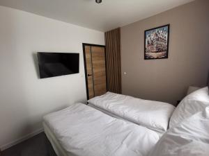 Posteľ alebo postele v izbe v ubytovaní Smart Apartament Grunwaldzka 240