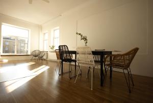 a dining room with a table and chairs at Liela Guest Apartament in Liepāja