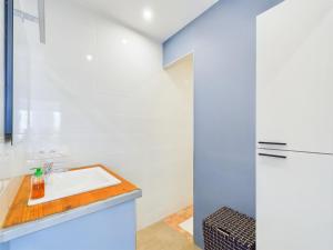 a kitchen with a sink and a refrigerator at Appart pour 4 centre ville - proche de la gare in Saint-Hilaire-de-Riez +15 photos