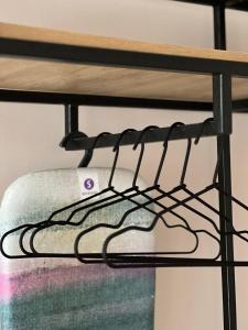 a iron shelf with towels on a bunk bed at Crown Hotel in Kutaisi