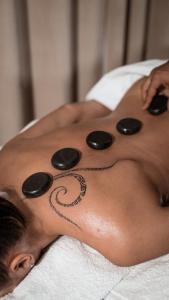 a woman with a tattoo on her back with pills at Downtown luxury segment in Braşov