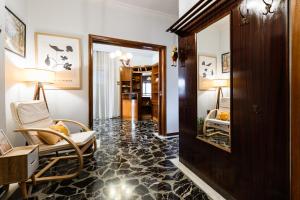a corridor of a hotel with a chair and a mirror at Chania Dream House in Chania +43 photos