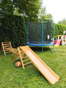 a playground with a trampoline and a basketball at Domek u Czesi in Podbiele
