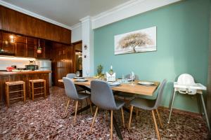 a dining room with a wooden table and chairs at Chania Dream House in Chania