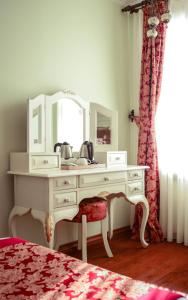 a room with a bed, dresser, mirror and a dresser at Hotel Sphendon in Istanbul