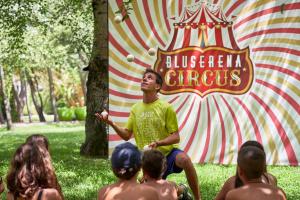 a man standing in front of a circus sign at Calaserena Resort in Geremèas