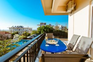 a blue table and chairs on a balcony with a view at Chania Dream House in Chania