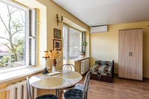 a dining room with a table and chairs and a window at Golden Dune Apartment in Klaipėda +7 photos