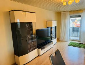 a living room with a large flat screen tv at Ferienunterkunft Monteurwohnung Hagenbach in Hagenbach